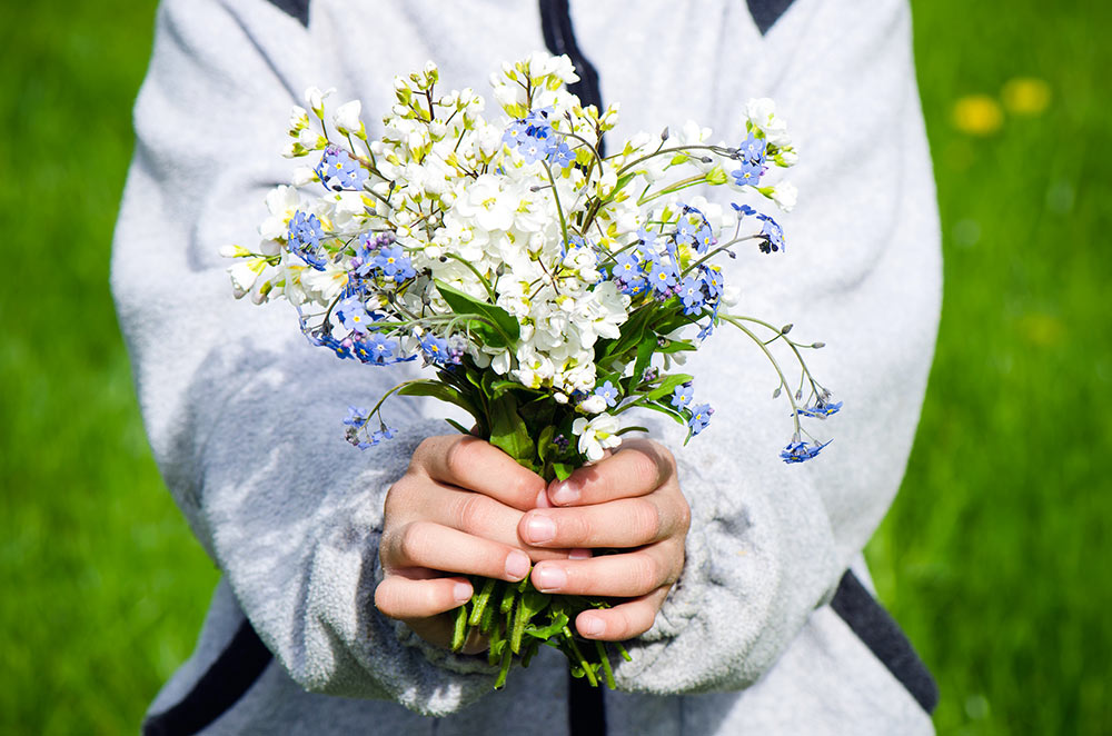 Child holding wild flowers